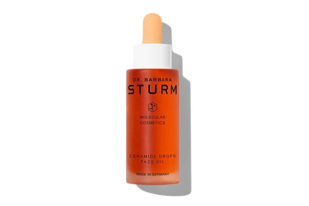 A small bottle containing orange liquid.