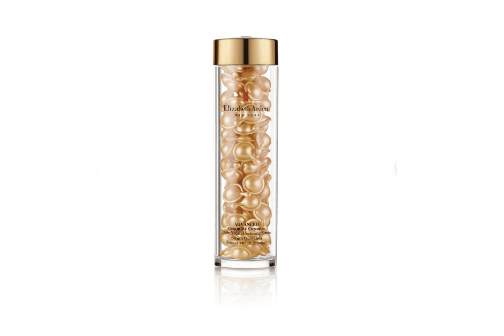 a bottle with gold capsules in it